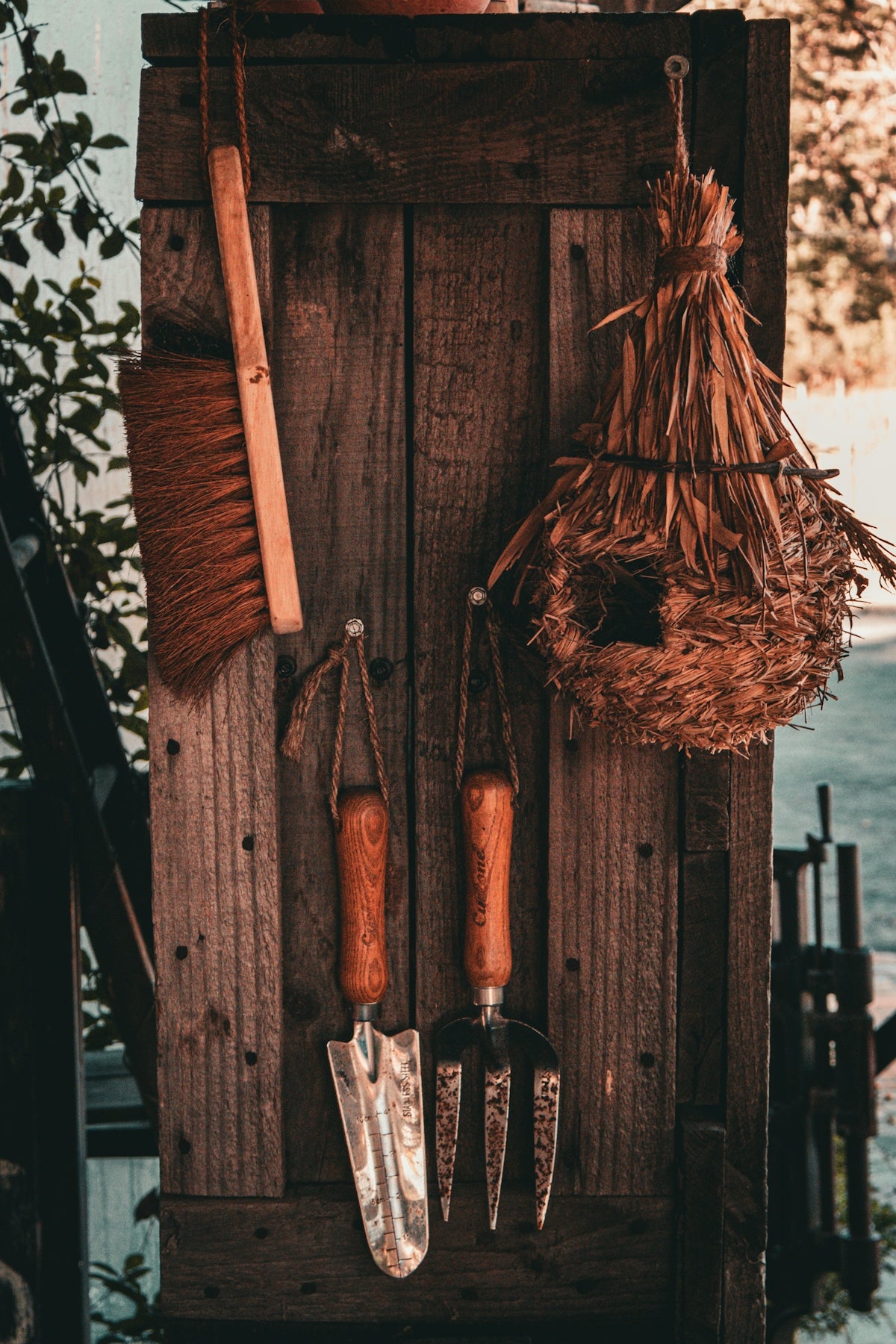 A wooden door with tools hanging on it