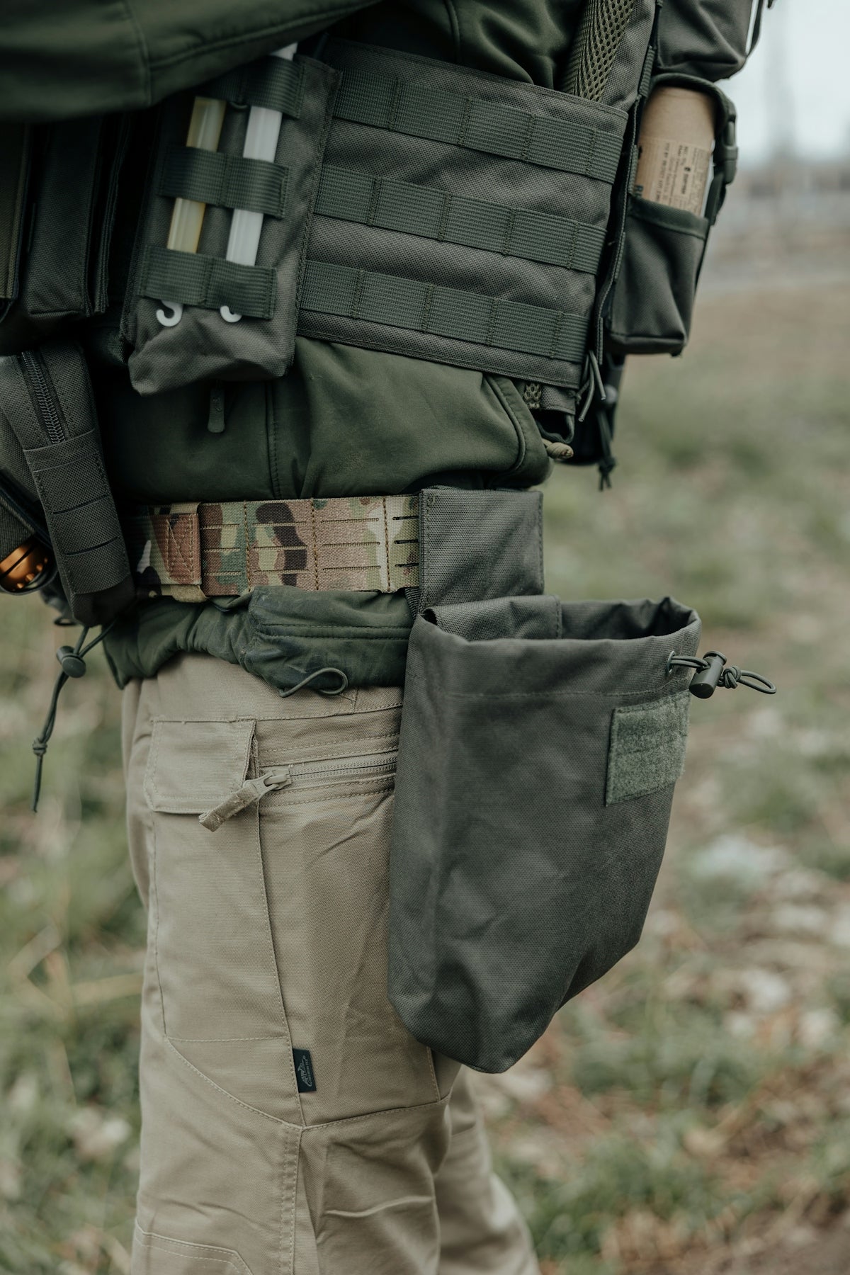 Soldier wearing tactical gear with a dump pouch.
